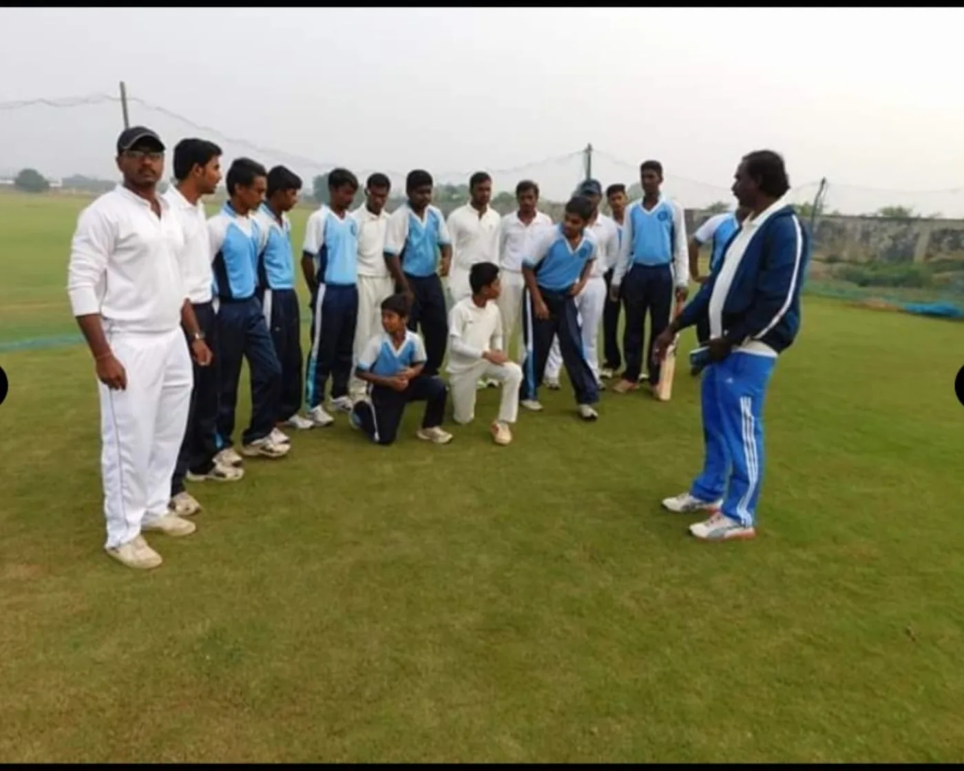 Cricket coaching discussion on the ground