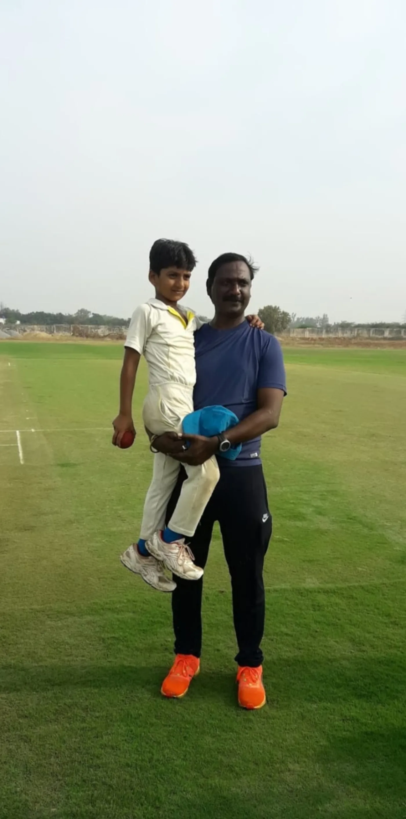Young cricketer standing with cricket kit