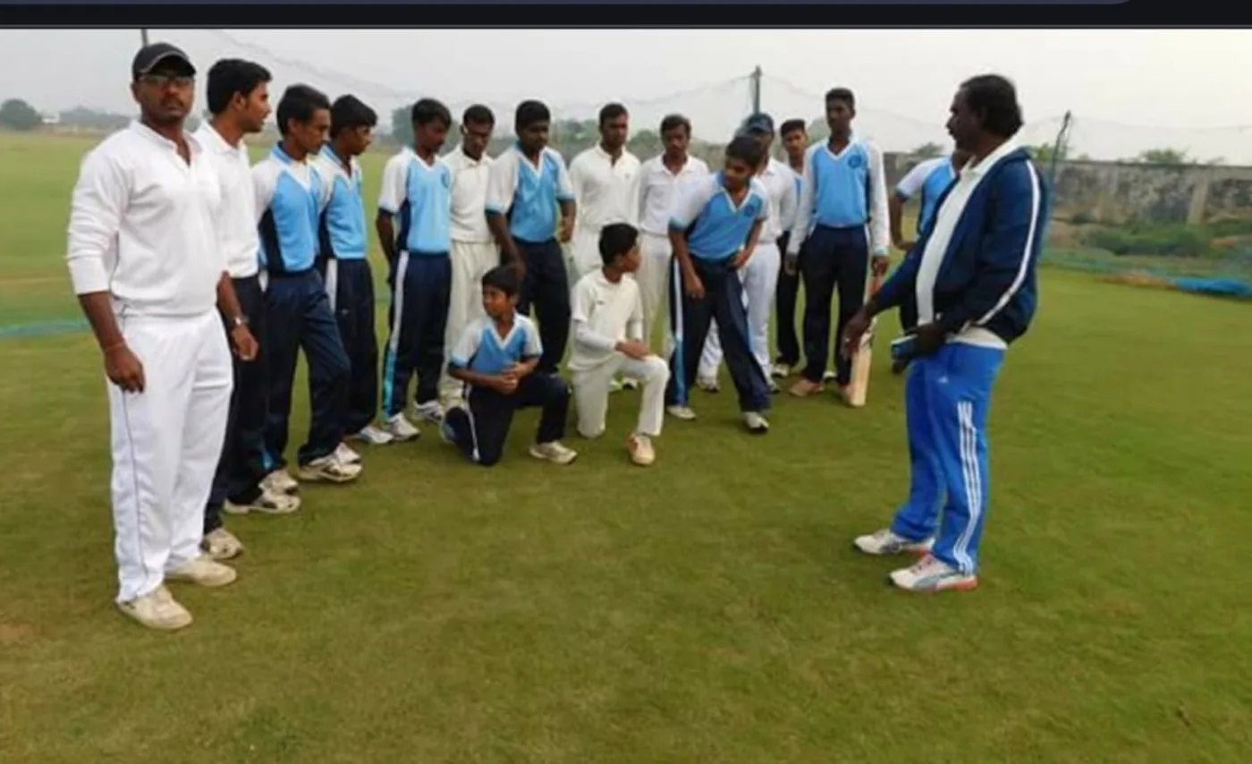 Students receiving cricket coaching on the field