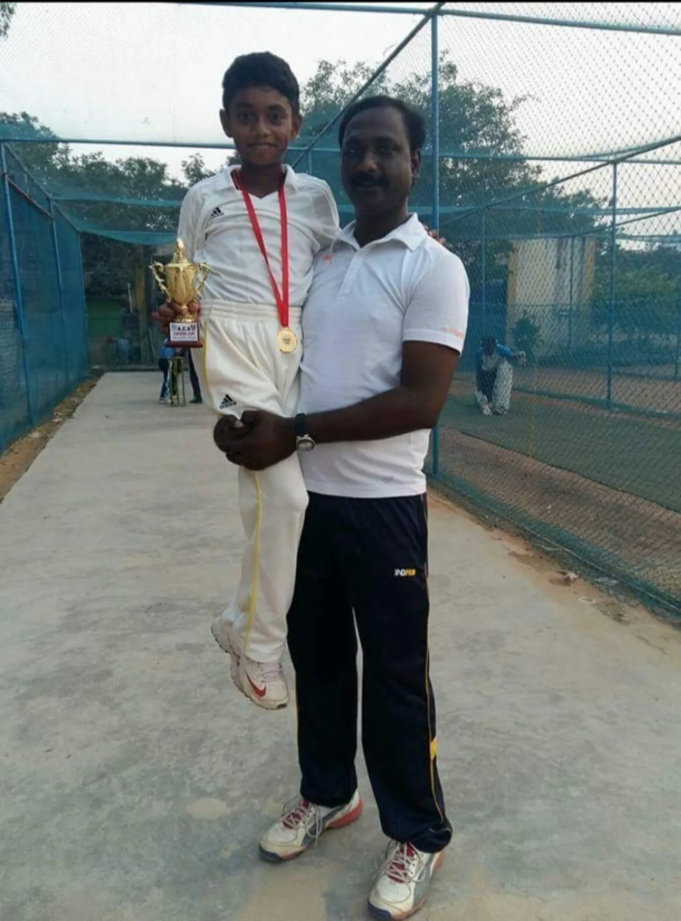 Coach with academy player at Standard Cricket Academy
