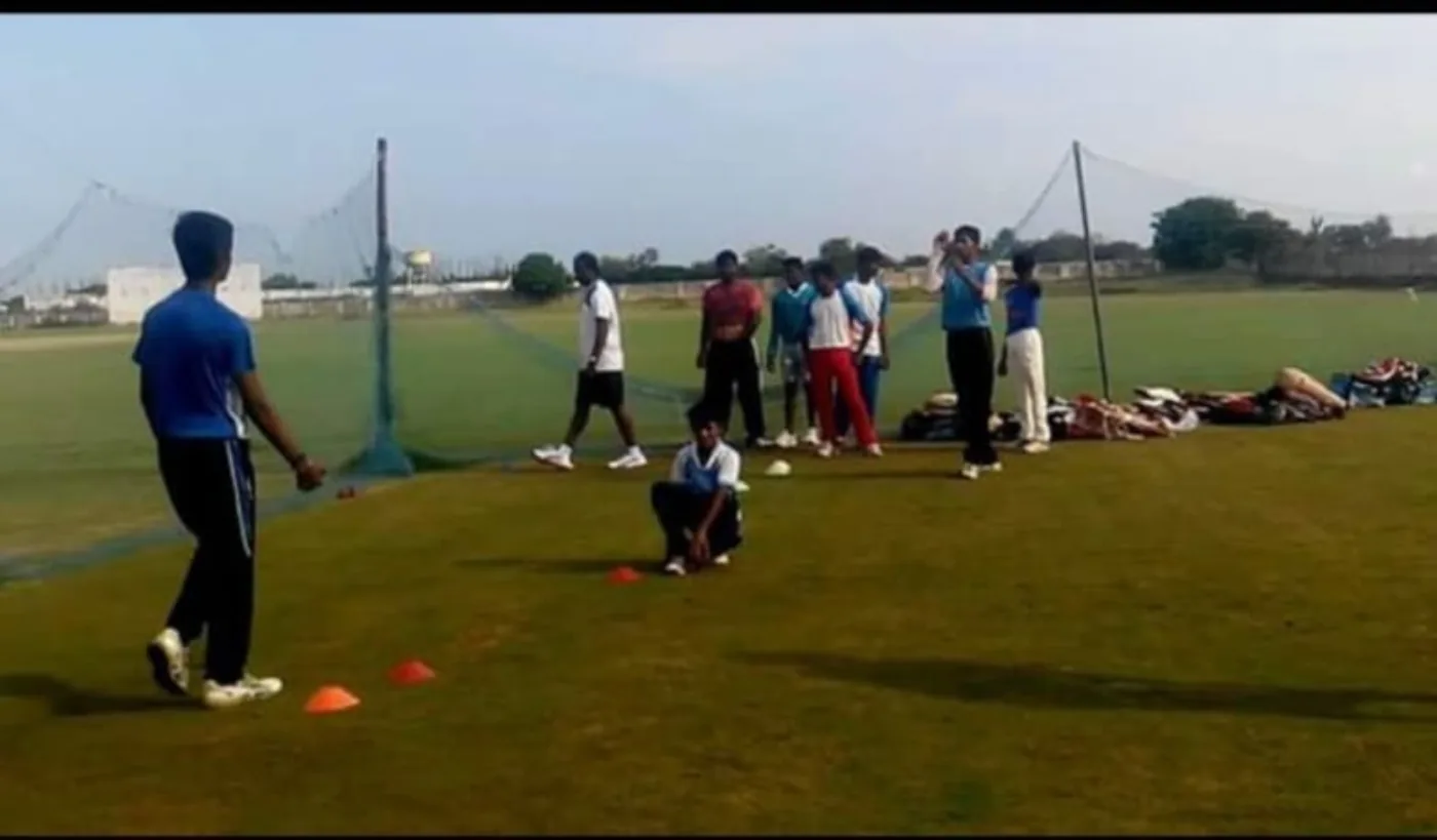 Cricket coaching drill on grass field
